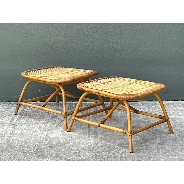 This pair of vintage low stools is a lightweight study in bent rattan, built with a simple, graceful silhouette. Each...