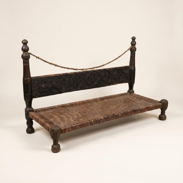 An antique charpai bench from the Swat Valley in northern Pakistan, hand carved in the chip carved tradition of the...