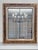 This mid century vintage wall mirror features a multi-layered frame combining a distressed, antiqued gold outer border...