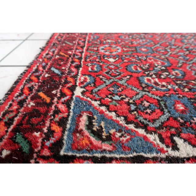 An exceptional Distressed Antique Persian Hamadan Runner from the renowned Hamadan region of Persia, dating to circa 1920....
