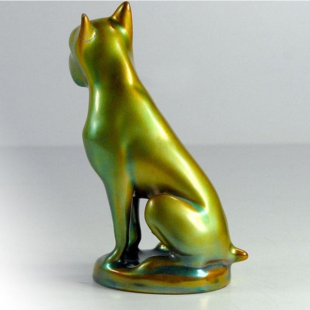 A figurine depicting a boxer-type dog made in the Zsolnay factory in Hungary. Decorated with beautiful, opalescent Eosine...