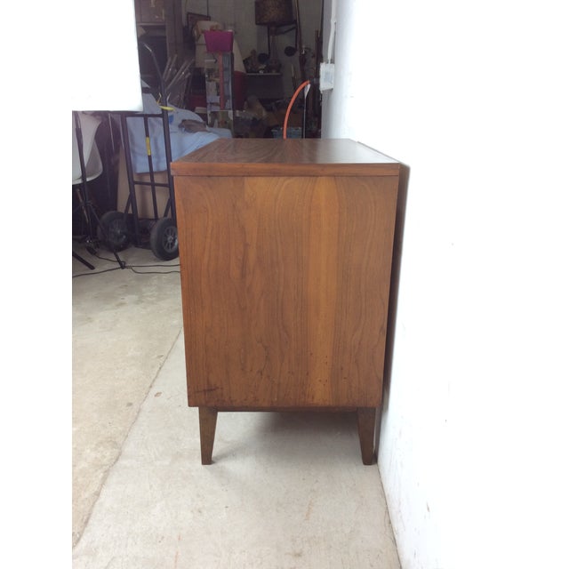 This mid century modern three drawer chest features hardwood construction, original walnut finish, three dovetailed...