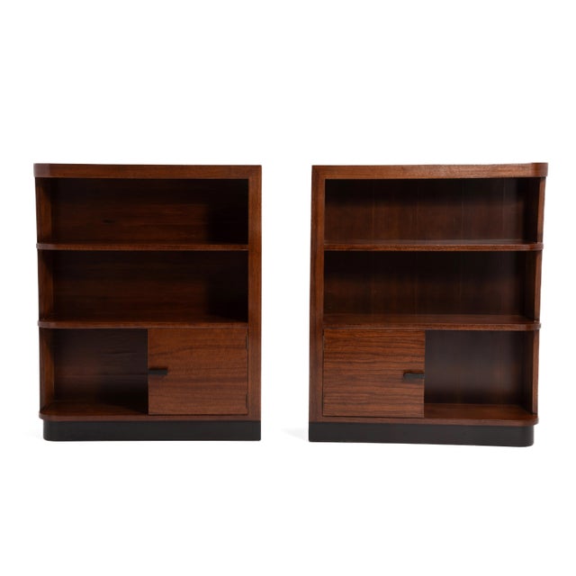 A pair of book-matched East India Laurel Wood Series bookcases (nos. 3634 and 3632) designed by Gilbert Rohde for Herman...