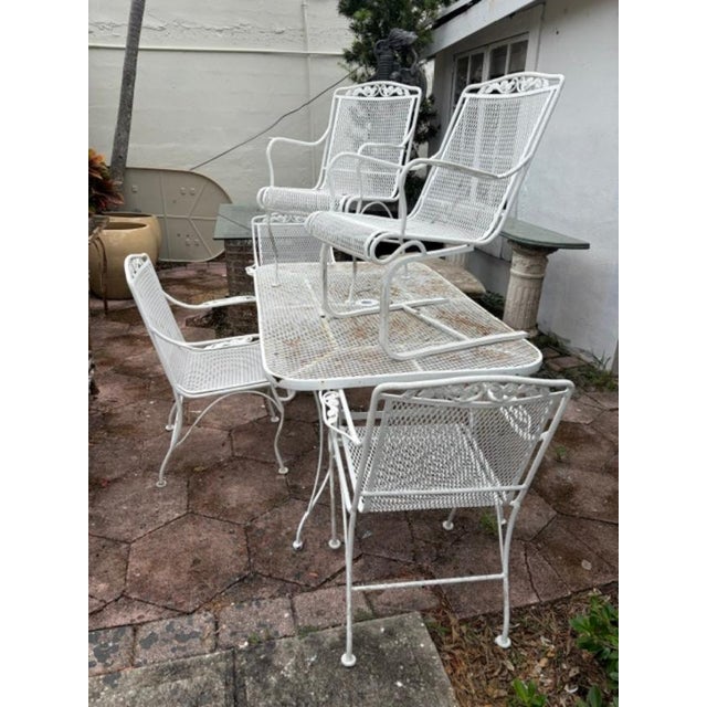 VINTAGE WROUGHT IRON PATIO DINING SET WITH TABLE AND SIX CHAIRS | A classic vintage wrought iron outdoor dining set...