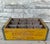 Vintage mid century wooden 12 bottle yellow painted crate with slat base and metal edge reinforcement band on corners....