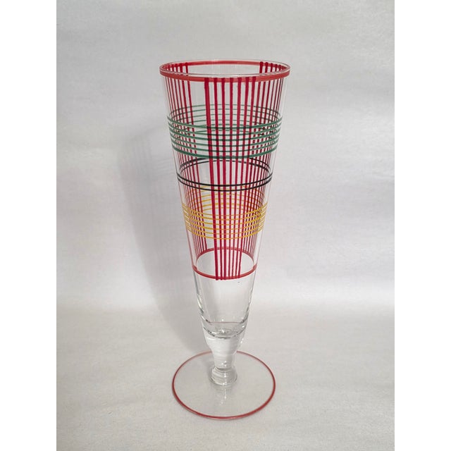 A colorful set of seven Mid-Century Modern era Art Deco styled tall conical Pilsner Beer Glasses decorated with prominent...
