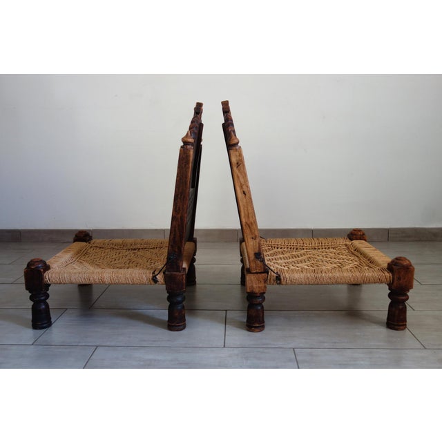 Pair of traditional Indian "pida" chairs dating from the 1950s/60s. Carved wooden frame and woven rope seat. Two small...