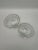 A pair of vintage clear glass scallop seashell dishes or trinket bowl with a ribbed texture and small resting feet.