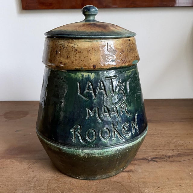 Glazed terracotta tobacco pot with various inscriptions and signed.