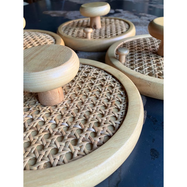 Set of four vintage mid-century modern Italian coat wall hooks in solid wood and woven cane. Each piece features a...