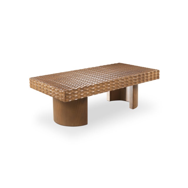 The centre table Malaparte, in solid wood, with his big wood top textured with the gougée technique, has his curved feet...