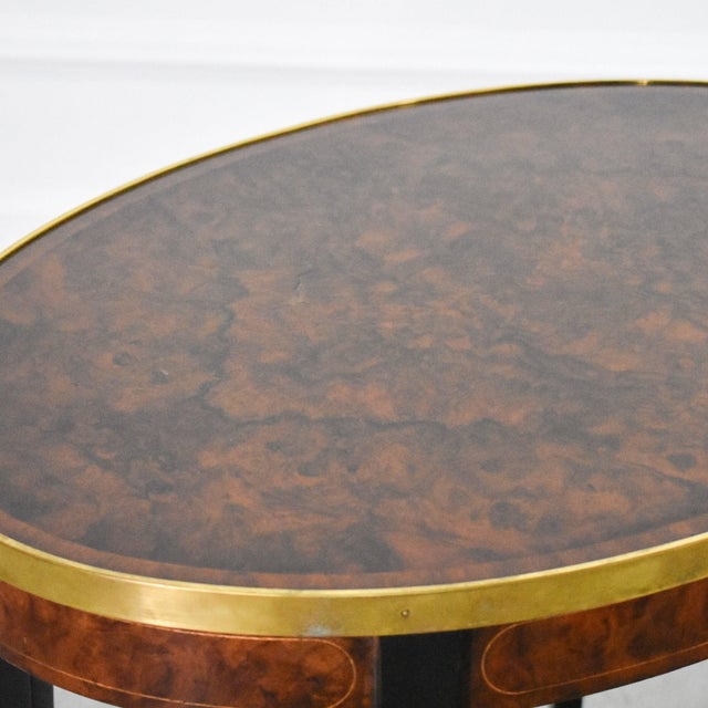 Stunning pair of regency styled walnut burl and brass trimmed oval side tables by Henredon. Tapered legs with a supportive...