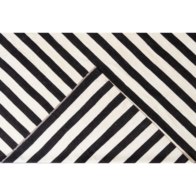 Beautiful 21st Century Contemporary Kilim Rug, hand-woven wool in an allover black and white striped design. This rug...