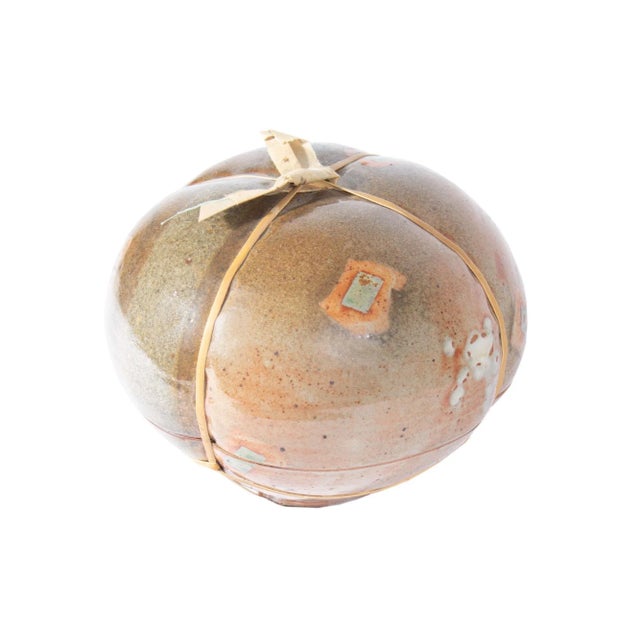 A studio pottery sculpture by the American artist Jeri Au (born 1953). This organic work is wrapped in bamboo and topped...