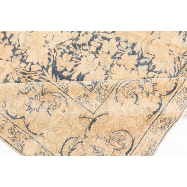 A late 19th century antique Persian tabriz rug from Northwest Persia, the midnight blue with staggered rows of lush camel-...