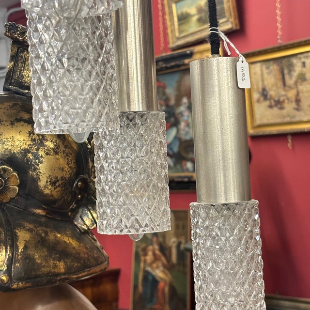 Beautiful 1970s wavy chandelier with 10 metal lights and adjustable glass shades. The black plate is easy to install with...