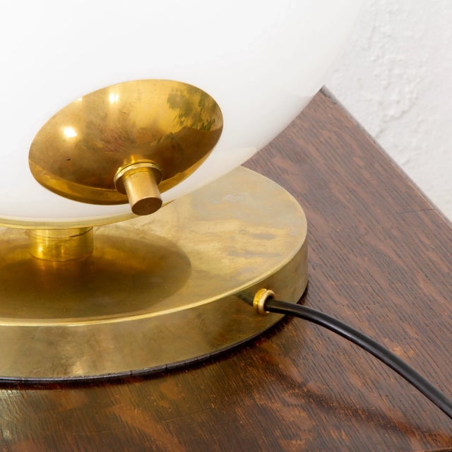 Italian Globe Table Lamp in Opal Glass and Brass, in Restored conditions. Designed 1950 to 1959 This piece is designed in...