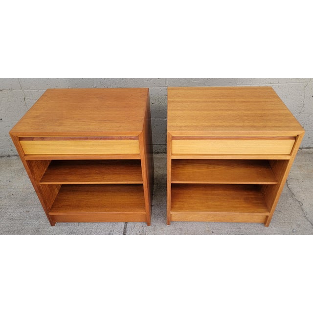 Classic pair of teak Danish Modern nightstands. Marked Made in Denmark". Circa. 1970's. Very nice original condition with...