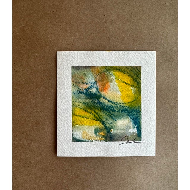 An expressive abstract watercolor alive with luminous golden yellows, moss greens, and deep ocean blues. Organic forms and...