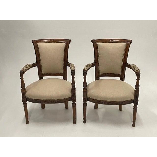 Elegant updated pair of French carved walnut armchairs tastefully and stylishly upholstered in oatmeal linen and...