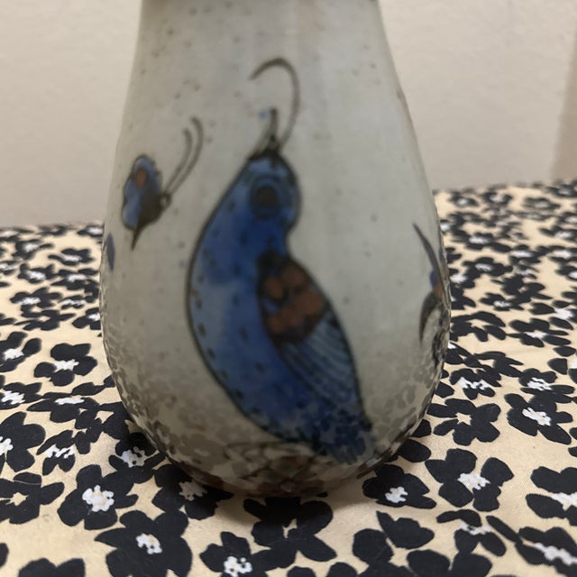 Add a touch of rustic charm and cultural artistry to your space with this beautiful Mexican pottery bud vase. Featuring a...