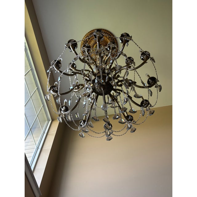 Large dramatic crystal entry chandelier with antique bronze/gold finish and multiple tiers of faceted hanging crystals....