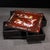 This is an exquisitely crafted wooden storage box featuring a unique swivel top mechanism and intricate mother-of-pearl...
