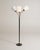 Black lacquered metal frame with brass details, three flexible arms, and white pleated fabric lampshades. Swedish...