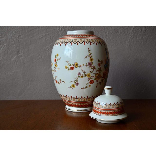 This large covered and richly decorated vase is a vintage Italian production with Japanese decoration. Two multicolored...