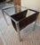 In the style of Mile Baughman. Chrome and glass table with leather magazine/document holder.