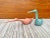 A striking pair of postmodern Pink and Teal ceramic Birds sculptures by Jaru Art Pottery of California. Dated 1985 Feature...