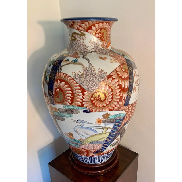 A late 19th Century Japanese Arita porcelain vase of tapered, ovoid form rising to a short cylindrical neck with everted...