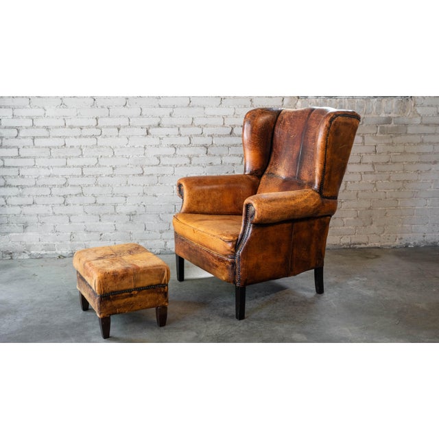 Art Deco 1970s Vintage Art Deco Distressed Cognac Leather Wingback Chair & Ottoman For Sale - Image 3 of 16