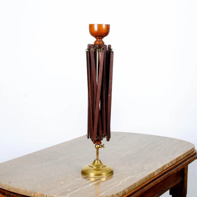 A 19th century umbrella swift yarn winder with brass base, rod and clamp and a turned wood finial cup. 20 inches wide...