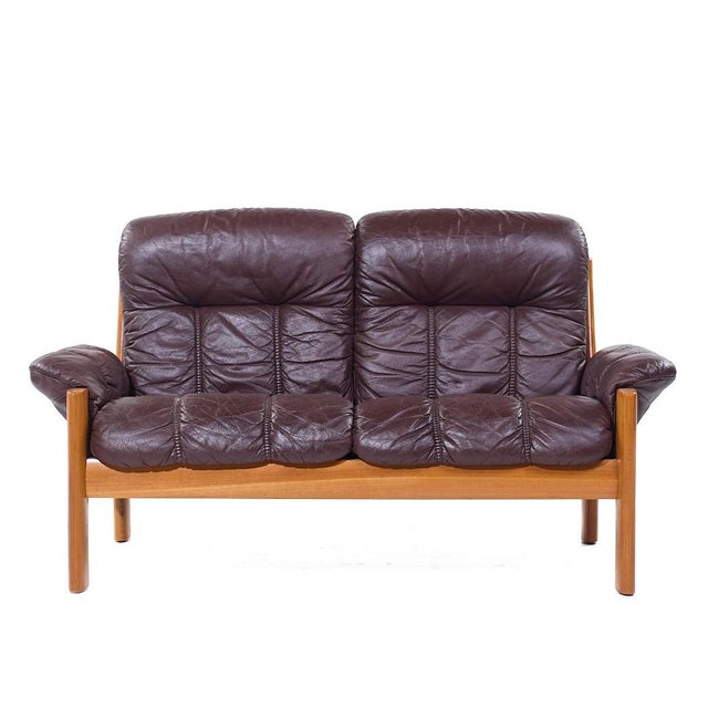 Ekornes Mid Century Danish Teak Leather Loveseat This loveseat measures: 60 wide x 33 deep x 34 inches high, with a seat...