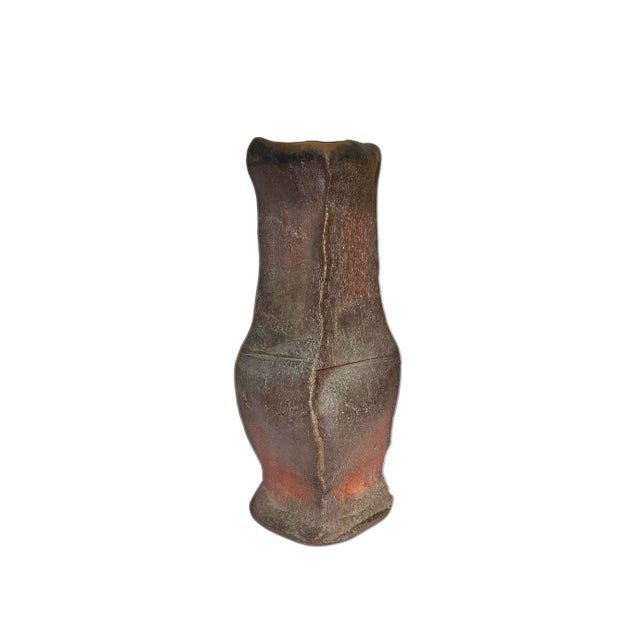 A skillful, earth toned studio pottery vase with a loosely thrown form and luscious wood fired surface