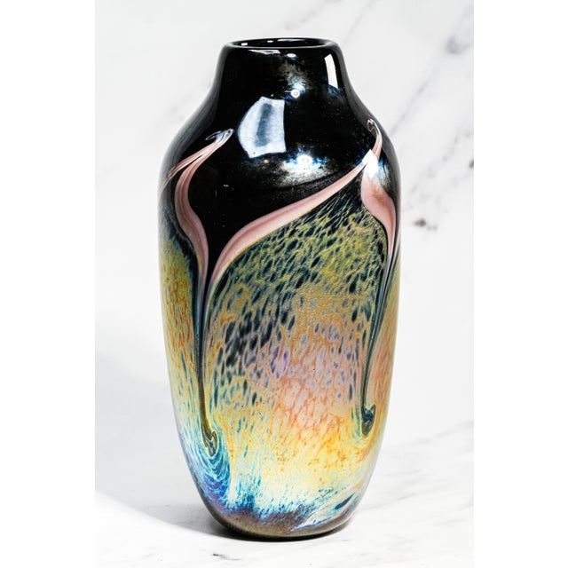A striking example of late 20th-century American studio art glass, this signed Steven Bradshaw vase captures the movement,...
