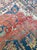 Antique Persian Serapi rug featuring a striking large central geometric medallion set against a muted rust field. Hand-...