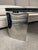 Striking Mid-Century Modern coffee table featuring a substantial triangular specimen granite top supported by three...