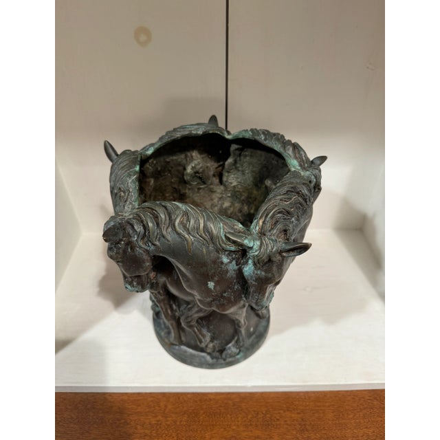 Great bronze horse vase with great design. The vase is a nice size with a nice aged look. The horses have great detail...