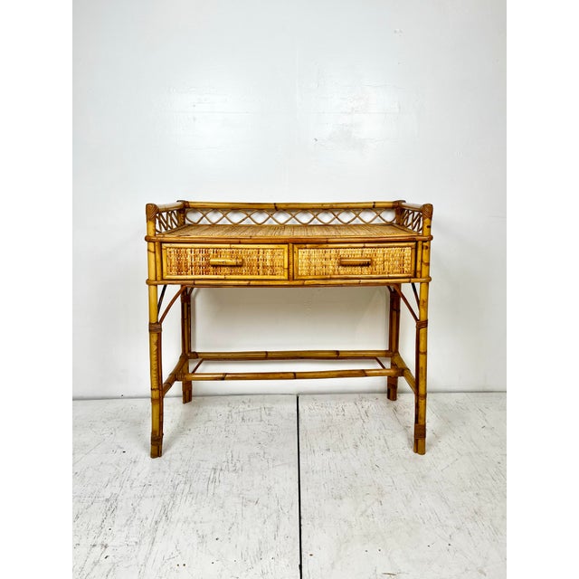 Vintage rattan bamboo desk. Rattan frame with woven cane wrapped top and drawers. Two drawers with pencil reed rattan...