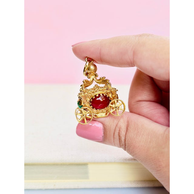 About This Pendant This exquisite vintage 18K yellow gold carriage pendant features two cabochon carnelians and two...