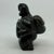 Hand Carved Signed Inuit Figure Blackstone Sculpture by Tytoosie Tunnillie Details: Hand carved 6" high Inuit blackstone...