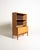 Oak bookcase with adjustable shelf and lower compartment closed by a vertical shutter, complete with a pull-out module...