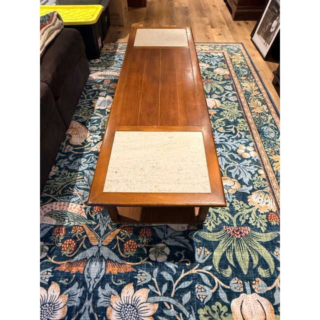 A vintage mid century coffee table by Lane Furniture likely from the 1950s-60s. The plank wood top has travertine inserts...