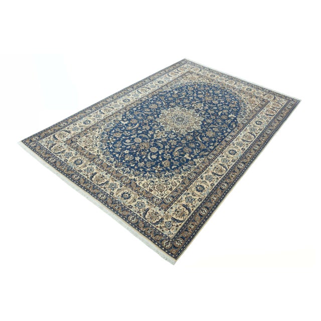 This exquisite Nain 9La oriental rug is a masterpiece of traditional knotting. Its finely crafted medallion on a royal...