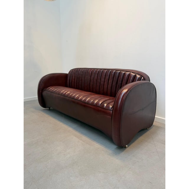 A stunning Mustang 3-seater sofa by the renowned British manufacturer Fleming & Howland . with its distinctive rounded...