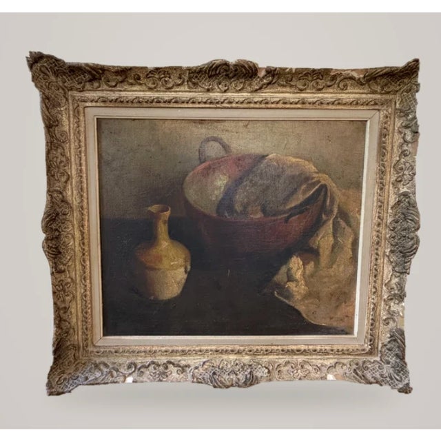 A quiet still life of an earthenware vessel, draped linen and a ceramic pitcher in warm umbers, ochres and soft shadow....