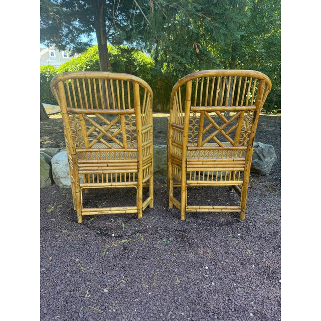 A pair of Vintage Brighton Pavilion Bamboo and Cane Chairs. A beautiful set of Vintage Pavilion style chairs with caned...