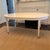 Highland House Hudson Dining Table A stunning oval dining table in a soft white finish with tapered legs and brass caps....